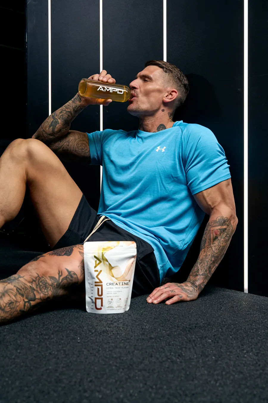 Ross drinking AMPD from the bottle between sets in the gym