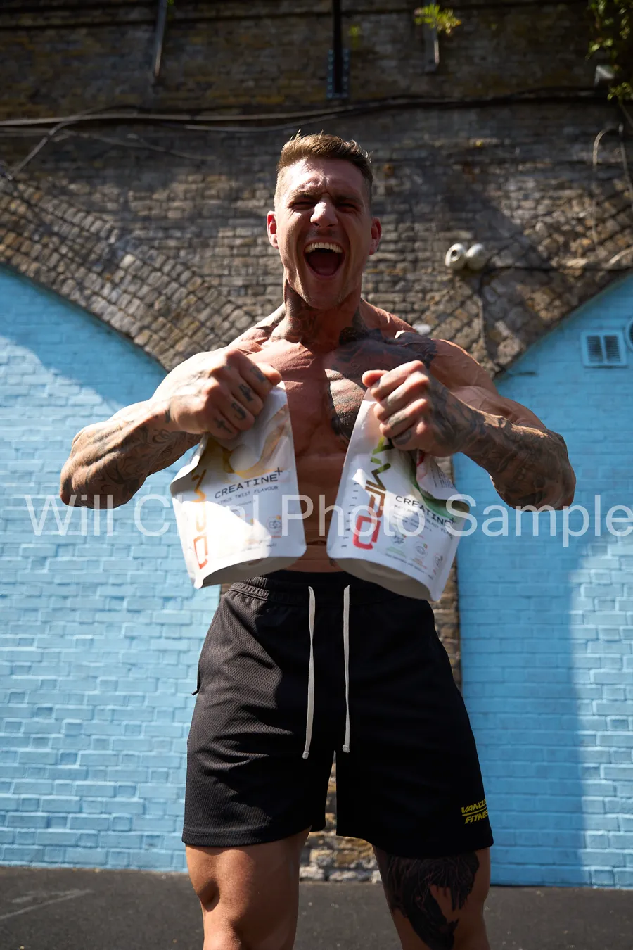 Ross holding both AMPD Creatine+ flavour pouches after training